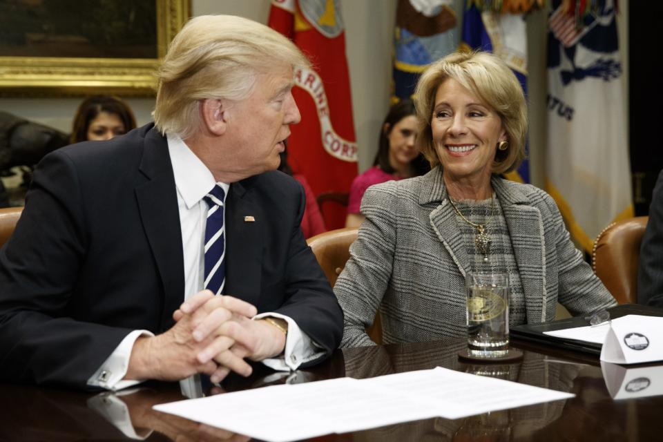 President Trump talks to Education Secretary Betsy DeVos in the Roosevelt Room of the White House in Washington on Feb. 14, 2017. Even as fierce political battles about school choice rage in Washington, most Americans know little about charter schools or private school voucher programs. (Photo: Evan Vucci/AP)