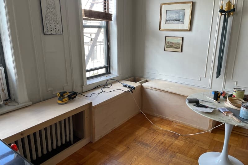 A window bench and radiator cover are under construction, and a white tulip table atop the marble awaits installation.