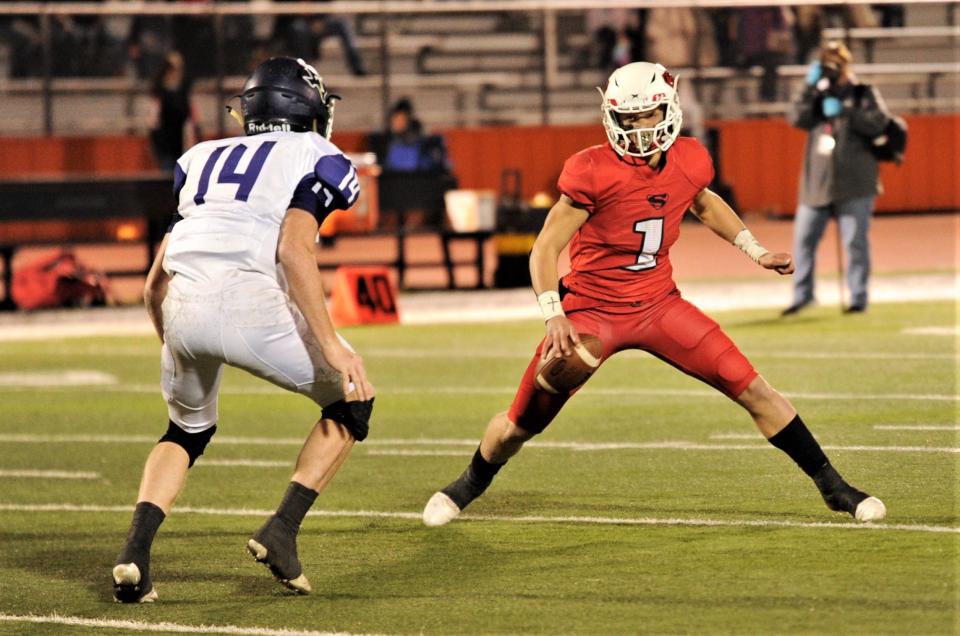 Strawn's Grayson Rigdon, right, tries to dance around Throckmorton's Zack Whitfield (14) while trying to throw the ball in the first quarter. Strawn won the Region III-1A Division II semifinal game 61-8 on Nov. 19 in Springtown.