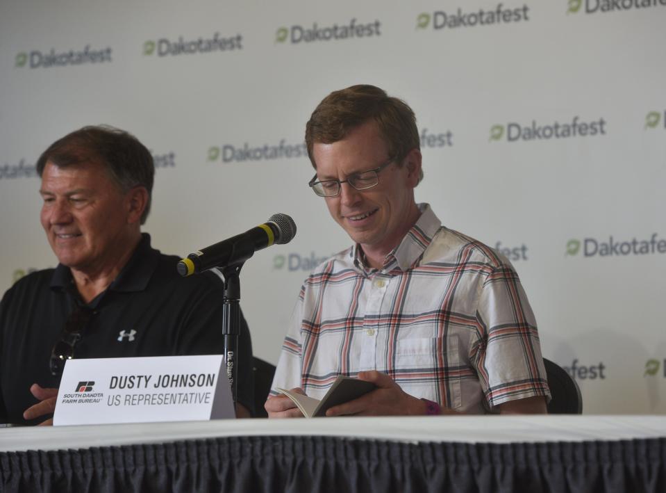 Rep. Dusty Johnson, R-SD, flips through his notes ahead of the congressional delegation update on the 2023 farm bill during Dakotafest in Mitchell on Wednesday, Aug. 16, 2023.