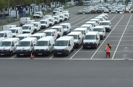 Delivery vehicles wait to be loaded at an Amazon logistics centre in Mannheim