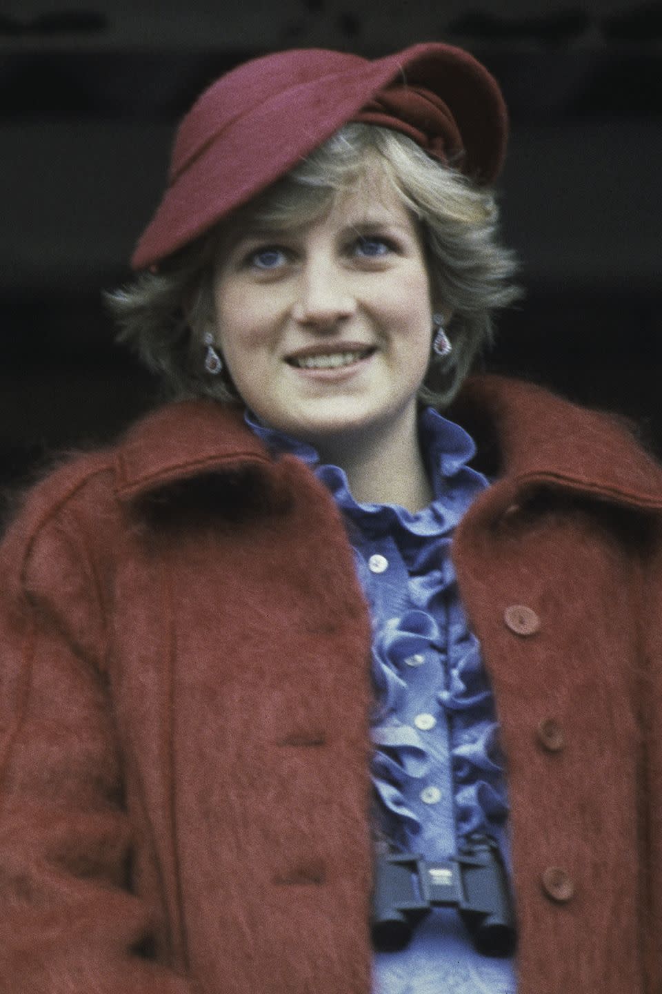 <p>Wearing a burgundy hat while attending the Aintree racecourse for the Grand National. </p>