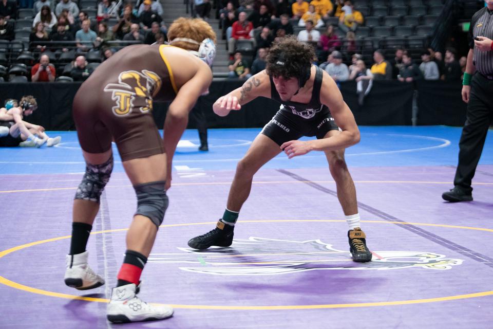 Pueblo South's Antonio Martinez faces off against David Estrada of Thomas Jefferson during their 120-pound first round matchup in the Class 4A state tournament at Ball Arena on Thursday, Feb. 16, 2023.