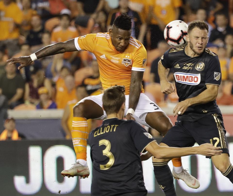 Houston Dynamo's Romell Quioto takes a shot against Philadelphia Union's Keegan Rosenberry during the second half of the U.S. Open Cup championship soccer match Wednesday, Sept. 26, 2018, in Houston. (AP Photo/David J. Phillip)