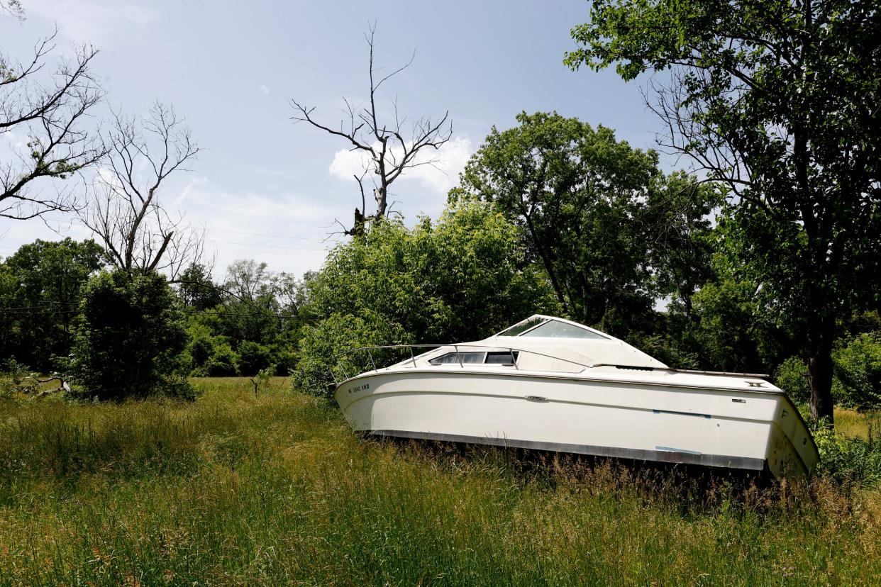 A large boat sits in an empty field off of Blackstone Street in the Brightmoor area of Detroit on Wednesday, June 15, 2022.