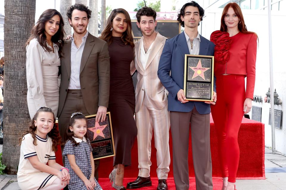 Danielle Jonas, Kevin Jonas, Priyanka Chopra, Nick Jonas, Joe Jonas, Sophie Turner, and (front) Alena Rose Jonas and Valentina Angelina Jonas attend The Hollywood Walk of Fame star ceremony honoring The Jonas Brothers on January 30, 2023 in Hollywood, California.