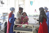 A woman cries after her husband died of a leakage in the oxygen plant of a hospital in Nashik, in the Indian state of Maharashtra, Wednesday, April 21, 2021. A local administrator in western India says 22 patients have died in a hospital when their oxygen supply was interrupted by a leakage in a supply tank. The official says the oxygen supply has since been resumed to other patients. (AP Photo)