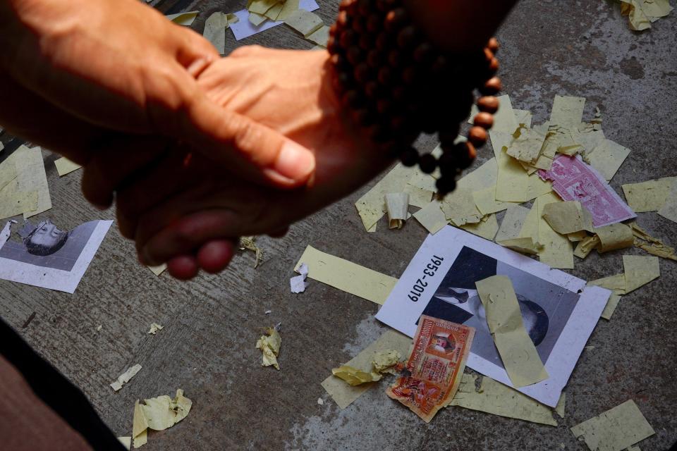 Anti-government protesters vandalize photographs of Chinese President Xi Jinping as they march in Hong Kong, Oct. 1, 2019. (Photo: Vincent Yu/AP)