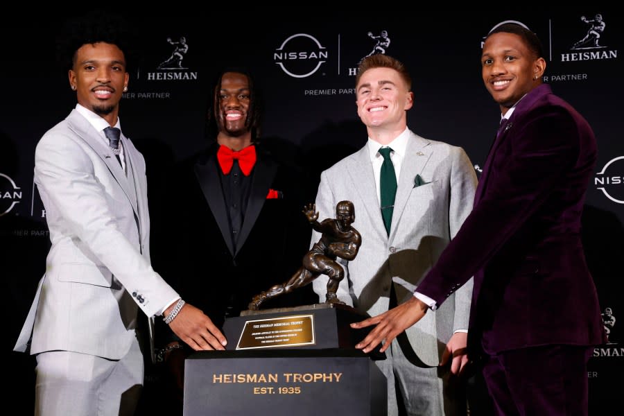 NEW YORK, NEW YORK – DECEMBER 09: (L-R) Quarterback Jayden Daniels of the LSU Tigers, wide receiver Marvin Harrison Jr. of the Ohio State Buckeyes, quarterback Bo Nix of the Oregon Ducks, and quarterback Michael Penix Jr. of the Washington Huskies pose with The Heisman Memorial Trophy during a press conference prior to the ceremony at New York Marriott Marquis Hotel on December 09, 2023 in New York City. (Photo by Sarah Stier/Getty Images)