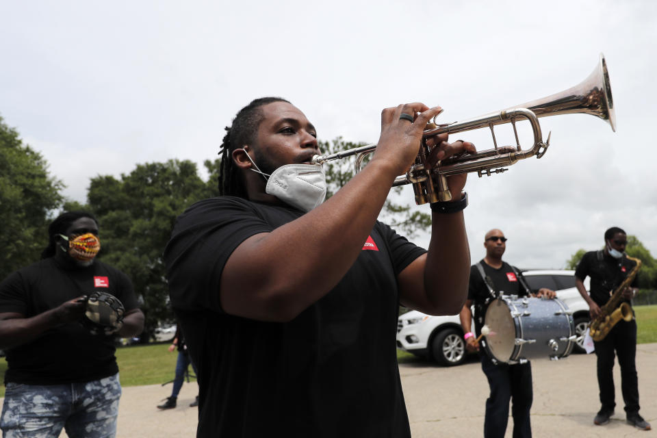 Members of the New Orleans Jazz Orchestra serenade healthcare workers at New Orleans East Hospital, as a tribute for their care of COVID-19 patients, outside the hospital in New Orleans, Friday, May 15, 2020. A New York woman collaborated with the New Orleans Jazz Orchestra to put on what she calls a stimulus serenade to give moral support to front-line hospital workers and COVID-19 patients in New Orleans. (AP Photo/Gerald Herbert)