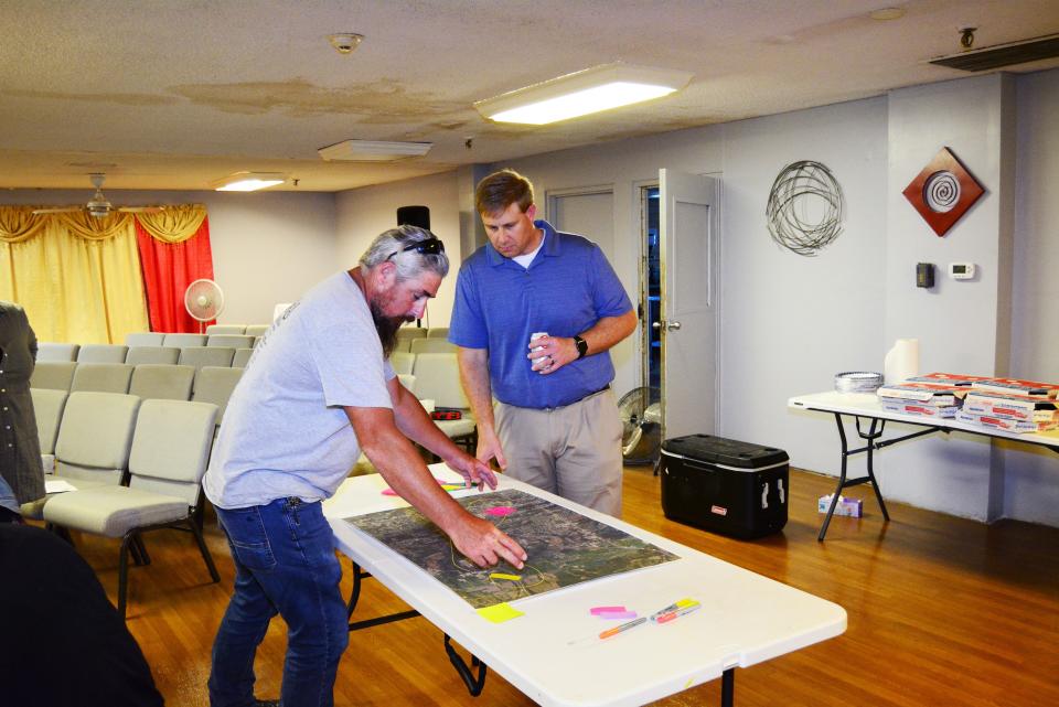 William Walters points out issues he's seen on Paris Road to Brian Rensing, transportation engineer with CBB Transportation Engineers and Planners, during a public meeting July 2022 at United Community Cathedral.