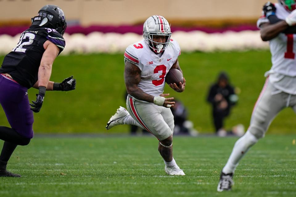 Nov 5, 2022; Evanston, Illinois, USA; Ohio State Buckeyes running back Miyan Williams (3) runs past Northwestern Wildcats linebacker Bryce Gallagher (32) during the second half of the NCAA football game at Ryan Field. Ohio State won 21-7. Mandatory Credit: Adam Cairns-The Columbus Dispatch