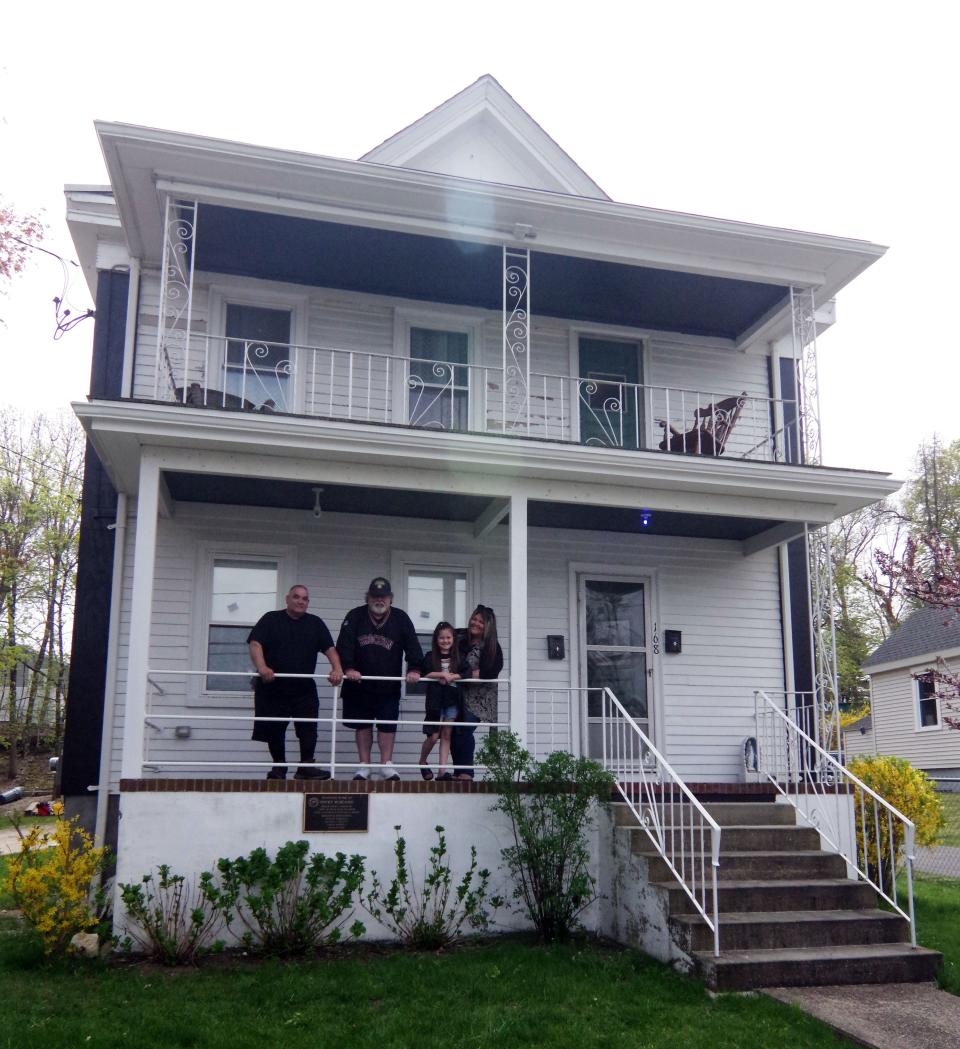 This is the Rocky Marciano family home at 168 Dover St. in Brockton. On the front porch is owner Mark Casieri, visitor David Martel, Martel's granddaughter Zelly Perez and his daughter Meaghan Perez, on Monday, April 29, 2024.