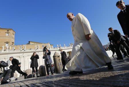 Pope Francis arrives to lead his Wednesday general audience in Saint Peter's square at the Vatican December 10, 2014. REUTERS/Stefano Rellandini