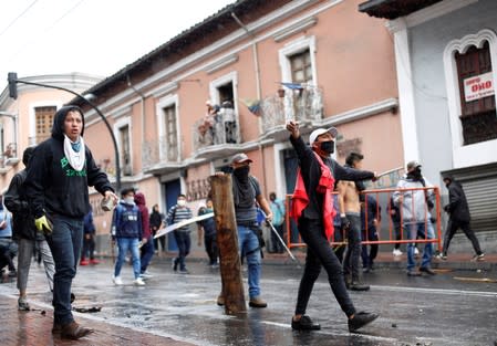 Demonstrators clash with riot police during a protest after Ecuadorian President Lenin Moreno's government ended four-decade-old fuel subsidies, in Quito