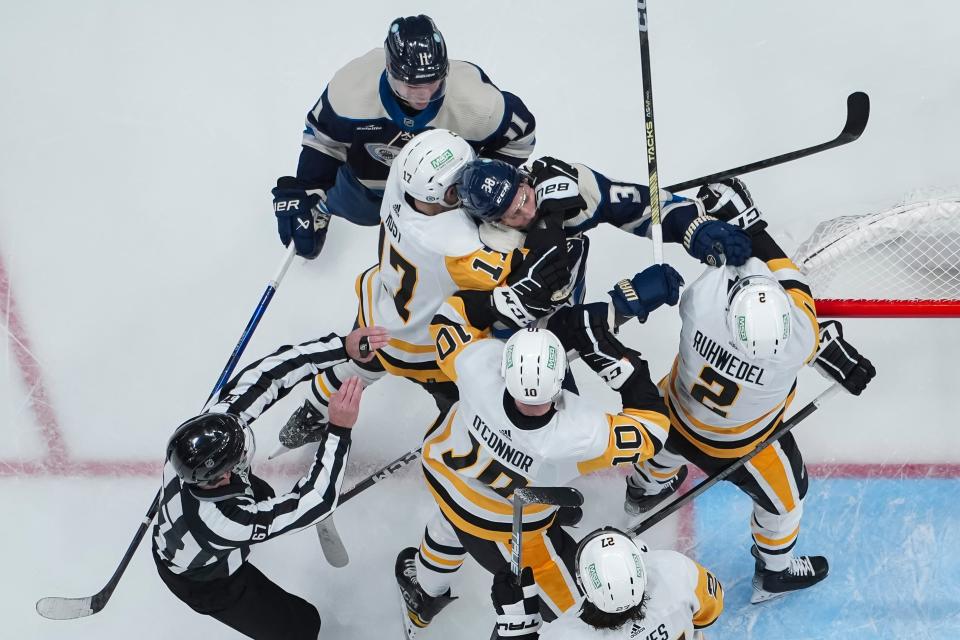 Blue Jackets center Boone Jenner (38) gets into a scrum with Penguins skaters Bryan Rust (17), Drew O'Connor (10) and Chad Ruhwedel (2).