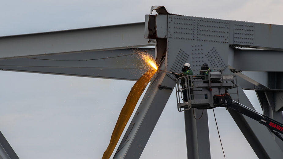 A photo released by the U.S. Coast Guard showed a demolition crew cutting a portion of the collapsed bridge for safe removal by a crane over the Patapsco River, in Baltimore, Maryland, on March 30, 2024.  / Credit: (U.S. Coast Guard photo by Petty Officer 3rd Class Kimberly Reaves)