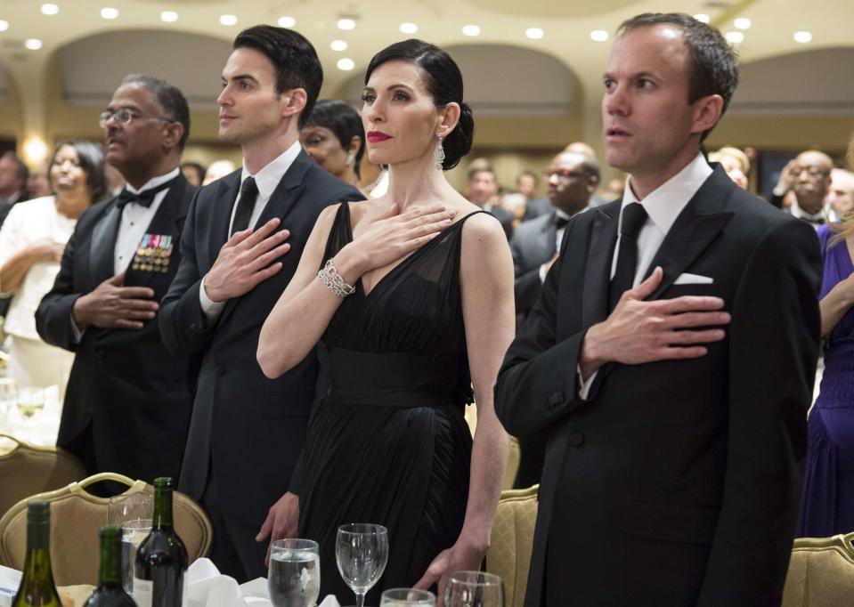 Actress Julianna Margulies stands with others at her table during the Pledge of Allegiance at the White House Correspondents' Association Dinner in Washington May 3, 2014. (REUTERS/Joshua Roberts)