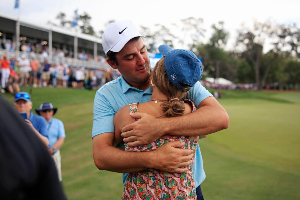 Scottie Scheffler hugs his wife Meredith Scudder after winning the tournament on hole 18 during the fourth and final round of The Players golf tournament Sunday, March 12, 2023 at TPC Sawgrass in Ponte Vedra Beach, Fla. Scottie Scheffler of Dallas won the tournament at 17 under par with Tyrell Hatton at 12 under par as runner-up.