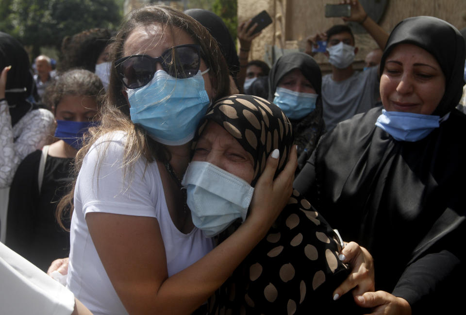 Relatives of Lebanese army lieutenant Ayman Noureddine, who was killed by Tuesday's explosion that hit the seaport of Beirut, mourn during his funeral procession, in Numeiriyeh village, south Lebanon, Friday, Aug. 7, 2020. Rescue teams were still searching the rubble of Beirut's port for bodies on Friday, nearly three days after a massive explosion sent a wave of destruction through Lebanon's capital. (AP Photo/Mohammed Zaatari)