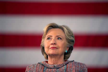 U.S. Democratic presidential nominee Hillary Clinton listens to former Vice President Al Gore talk about climate change at a rally at Miami Dade College in Miami, Florida, U.S. October 11, 2016. REUTERS/Lucy Nicholson