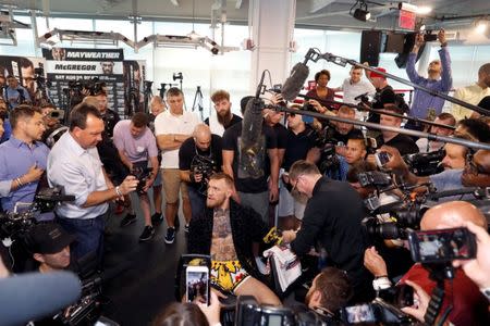 Conor McGregor of Ireland is surrounded by members of the media before a workout at the UFC Performance Center in Las Vegas, Nevada, U.S., August 11, 2017. REUTERS/Steve Marcus