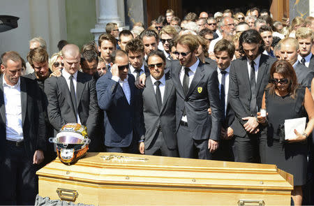 Formula One drivers Jean-Eric Vergne (4thR) and Felipe Massa (C), friends and relatives gather around the coffin of late Marussia F1 driver Jules Bianchi during the funeral ceremony at the Sainte Reparate Cathedral in Nice, France, July 21, 2015. Bianchi, 25, died in hospital in Nice on Friday, nine months after his crash at Suzuka in Japan and without regaining consciousness. REUTERS/Jean-Pierre Amet