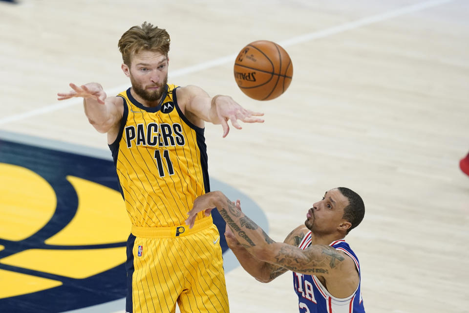 Indiana Pacers' Domantas Sabonis (11) makes a pass against Philadelphia 76ers' George Hill (33) during the second half of an NBA basketball game, Tuesday, May 11, 2021, in Indianapolis. Indiana won 103-94. (AP Photo/Darron Cummings)