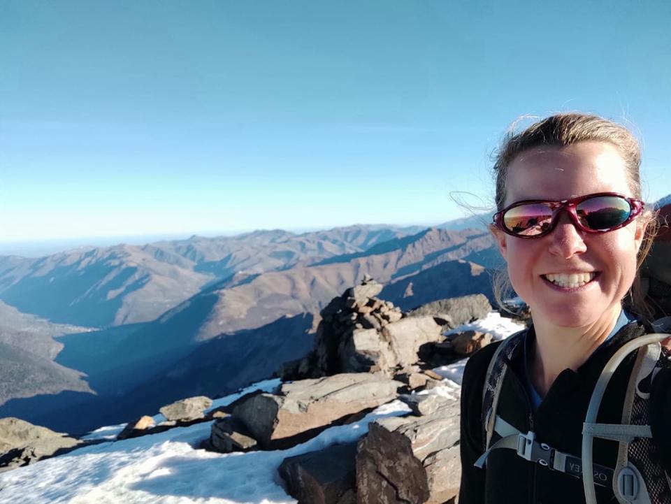 Esther Dingley smiles at the top of Pic de Sauvegarde in the Pyrenees.