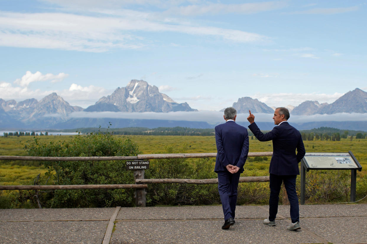 U.S. Fed Chair Jerome Powell and Governor of the Bank of England Mark Carney chat during the three-day 