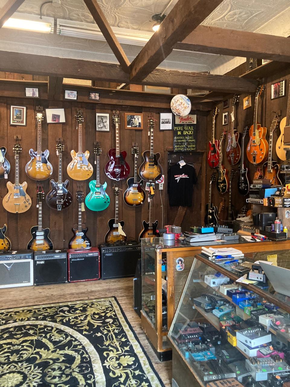 Vintage electric guitars, amps and musical gadgets on display in the front room of Mike's Music on Short Vine.