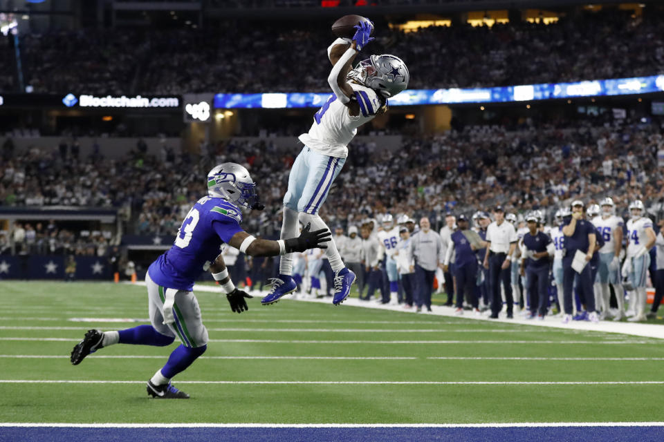 Dallas Cowboys wide receiver Brandin Cooks (3) catches a pass for a first down as Seattle Seahawks safety Jamal Adams (33) defends in the first half of an NFL football game in Arlington, Texas, Thursday, Nov. 30, 2023. (AP Photo/Roger Steinman)