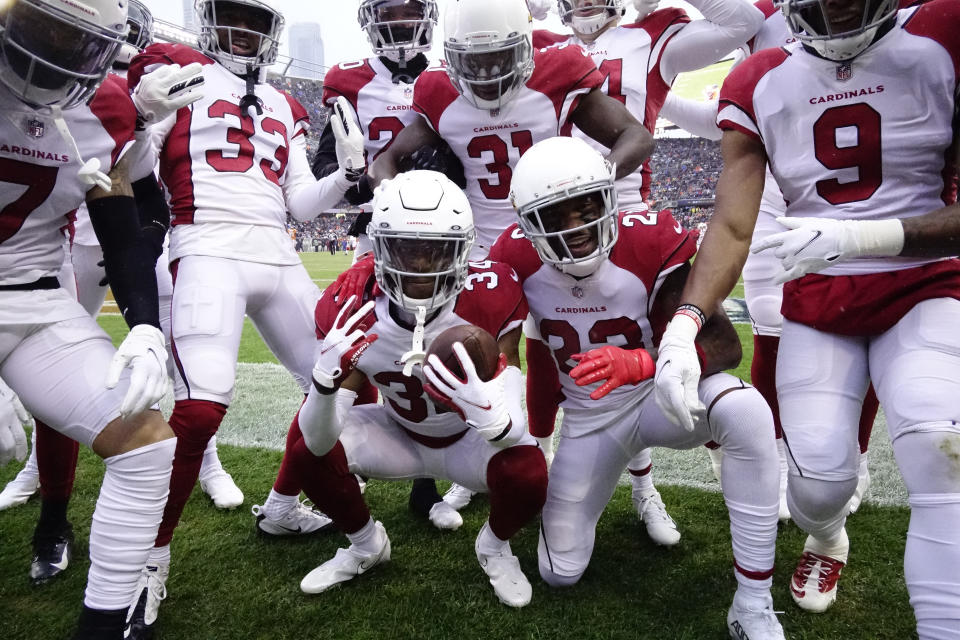 Arizona Cardinals free safety Jalen Thompson celebrates with teammates his interception of a Chicago Bears quarterback Andy Dalton pass during the first half of an NFL football game Sunday, Dec. 5, 2021, in Chicago. (AP Photo/David Banks)