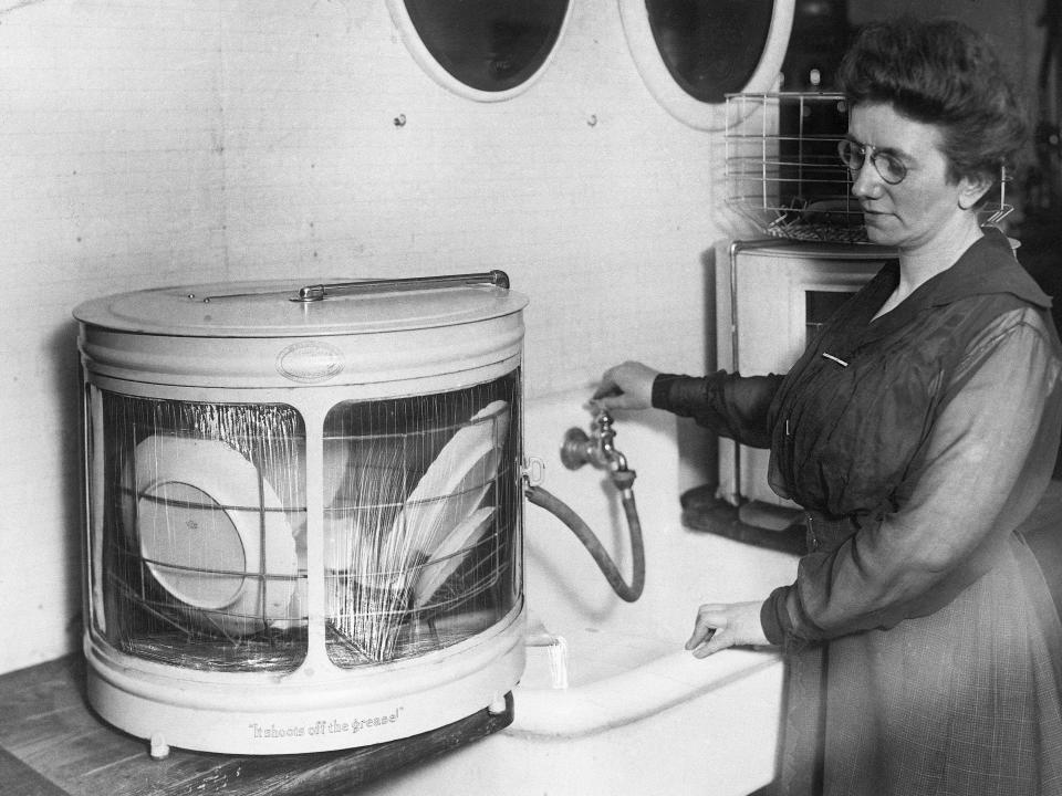 A woman with one of the earliest dishwashers. 