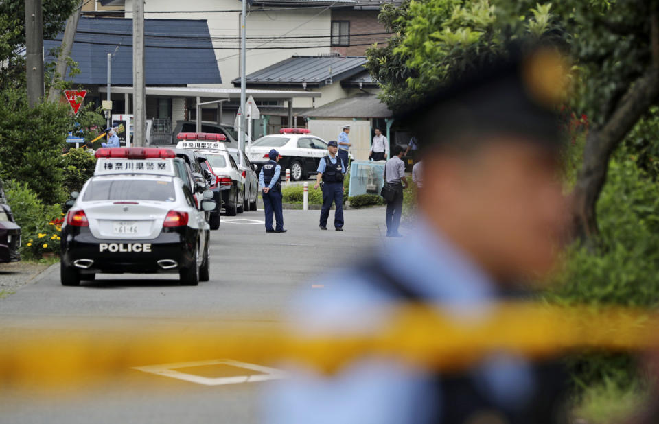 <p>Police officers stand guard at a crossroad near the Tsukui Yamayuri-en, a facility for the mentally disabled where a number of people were killed and dozens injured in a knife attack in Sagamihara, outside of Tokyo, Japan, Tuesday, July 26, 2016. (AP Photo/Eugene Hoshiko)</p>