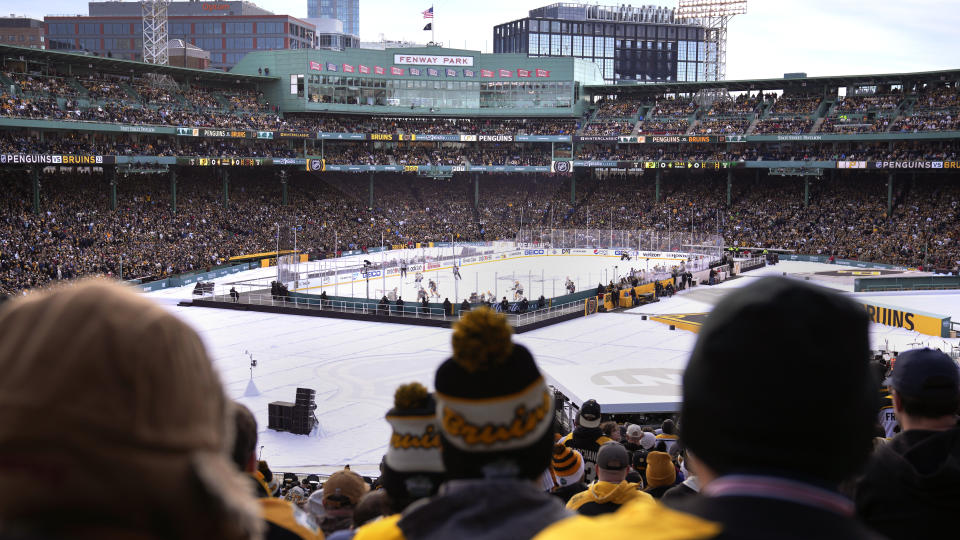 Fans watch as the Pittsburgh Penguins play the Boston Bruins during the first period of the NHL Winter Classic hockey game at Fenway Park, Monday, Jan. 2, 2023, in Boston. (AP Photo/Charles Krupa)