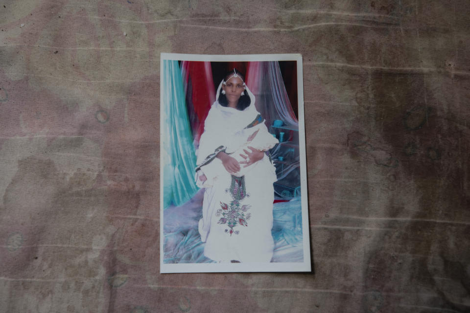 A photograph of Letay, the deceased wife of 40-year-old Tigrayan Abraha Kinfe Gebremariam, is seen inside her family's shelter in Hamdayet, eastern Sudan, near the border with Ethiopia, on March 14, 2021. Letay experienced a seemingly normal pregnancy in the Tigrayan region of Ethiopia. But ten days after giving birth to twin daughters, she passed away. (AP Photo/Nariman El-Mofty)