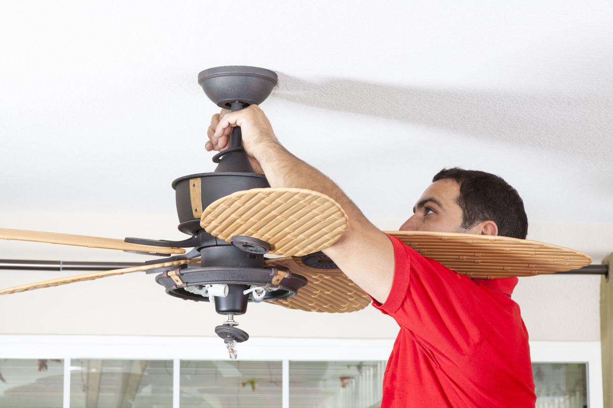 man installing ceiling fan