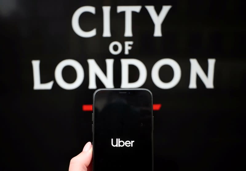 The Uber logo is displayed on a mobile phone in this picture illustration