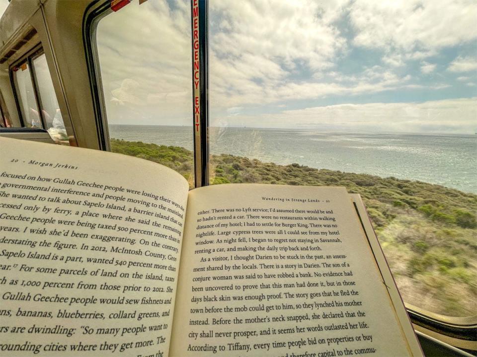 book open in front of train window