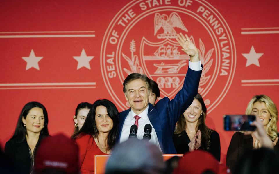 Mehmet Oz, US Republican Senate candidate for Pennsylvania, center, waves while speaking during an election night rally in Newtown, Pennsylvania - Michelle Gustafson/Bloomberg