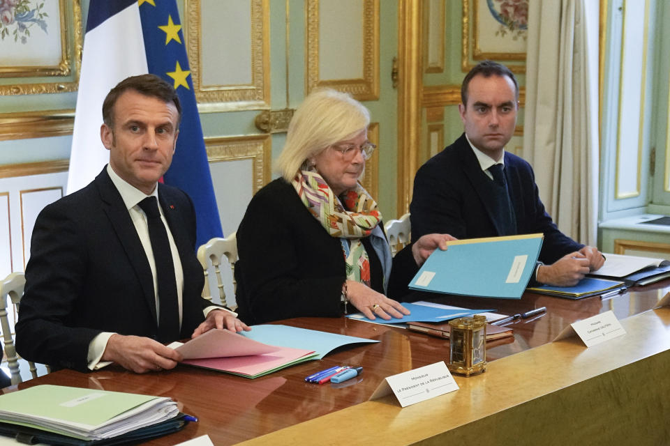 French President Emmanuel Macron, left, newly appointed French Minister for Labour, Health and Solidarities Catherine Vautrin, center, and French Defence Minister Sebastien Lecornu, right, attend the first meeting of the new cabinet after a cabinet reshuffle, Friday, Jan. 12, 2024 at the Elysee Palace in Paris. (AP Photo/Michel Euler, Pool)