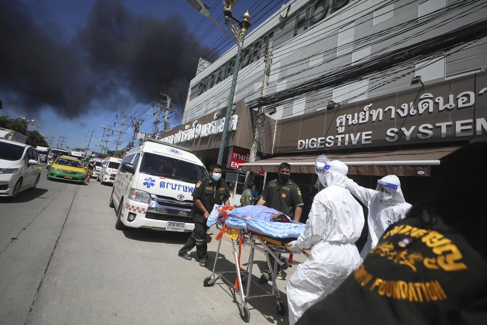 Patients are evacuated from the Chularat 9 Hospital following a massive explosion and fire at a factory in the Samut Prakan province, Thailand, Monday, July 5, 2021. A massive explosion at a factory on the outskirts of Bangkok early Monday shook an airport terminal serving Thailand's capital and prompted the evacuation of residents from the area. (AP Photo/Nava Natthong)