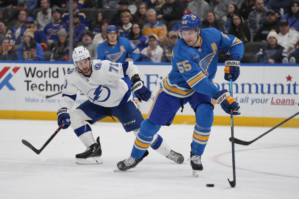 St. Louis Blues' Colton Parayko (55) controls the puck as Tampa Bay Lightning's Anthony Cirelli (71) defends during the third period of an NHL hockey game Saturday, Jan. 14, 2023, in St. Louis. (AP Photo/Jeff Roberson)