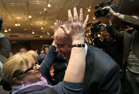 Slovakia's presidential candidate Andrej Kiska (R) is congratulated by his supporter at his party headquarters after the first unofficial results showed he won the presidential run-off elections in Bratislava March 29, 2014. Philanthropist and former businessman Kiska took a wide lead over Prime Minister Robert Fico in Slovakia's presidential election, partial results of the second election round showed on Saturday. REUTERS/David W Cerny