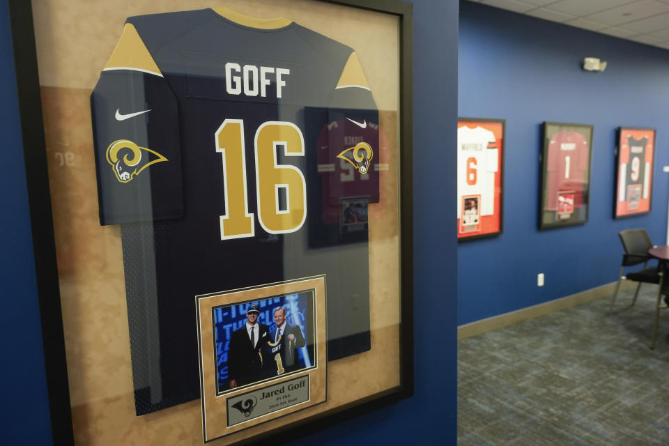A framed Los Angeles Rams Jared Goff jersey hangs on the the wall at STAHLS' in St. Clair Shores, Mich., Monday, April 22, 2024. STAHLS' rapidly personalizes jerseys for each first-round pick as they are announced at the NFL draft. (AP Photo/Paul Sancya)