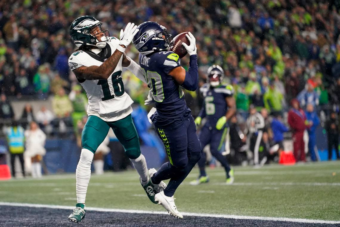 Seattle Seahawks safety Julian Love, right, prepares to make an intercepted on a pass intended for Philadelphia Eagles wide receiver Quez Watkins (16) during the second half of an NFL football game, Monday, Dec. 18, 2023, in Seattle. (AP Photo/Lindsey Wasson)