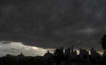 FILE - In this Jan. 23, 2021, file photo, heavy clouds move over Los Angeles city skyline. California's hopes for a wet "March miracle" did not materialize and a dousing of April 2021 showers may as well be a mirage at this point. California Gov. Gavin Newsom on Monday, May 10, 2021, declared a drought emergency for most of California, extending a previous order that affected two counties to 41 counties throughout much of the state. (AP Photo/Damian Dovarganes, File)