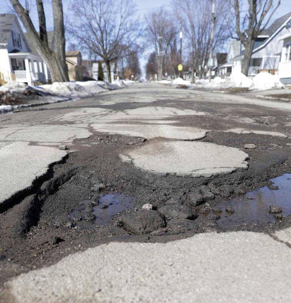 Potholes stretch across the 1100 block of Chicago Street on March 19, 2019, in Green Bay.