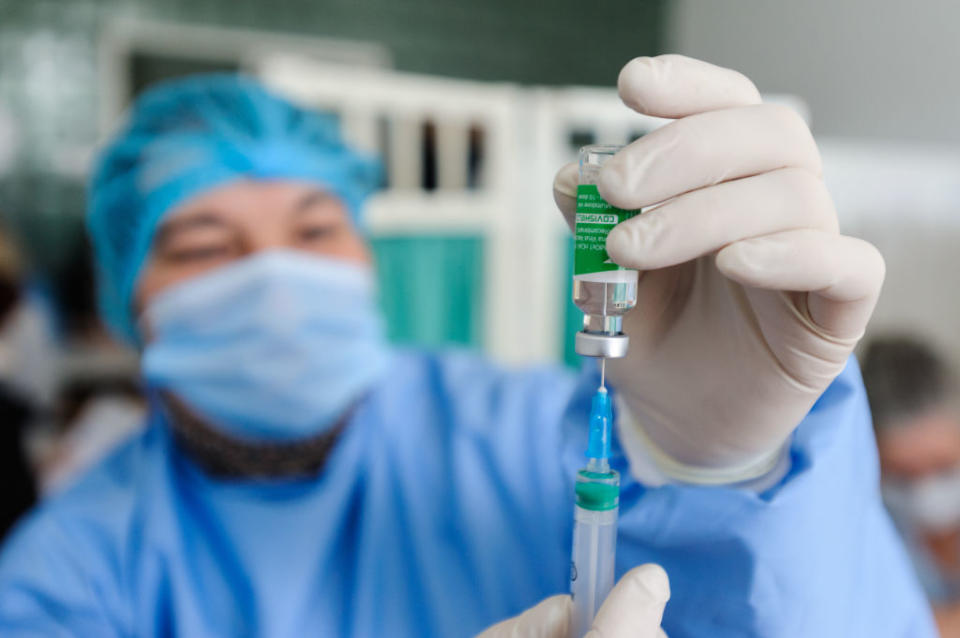  A health worker prepares a dose of AstraZeneca vaccine. 